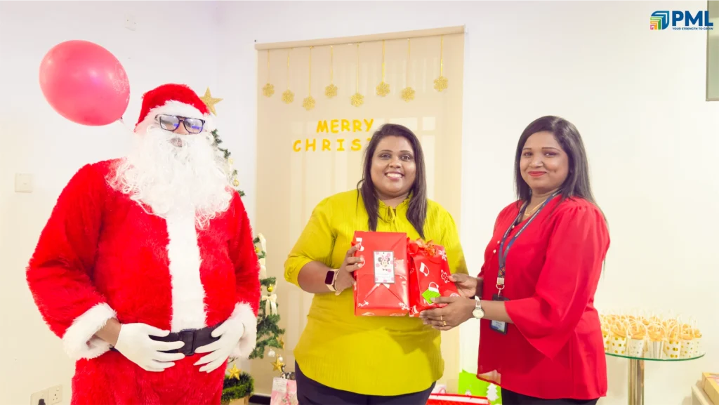 Employees receiving gifts from Santa in office 35