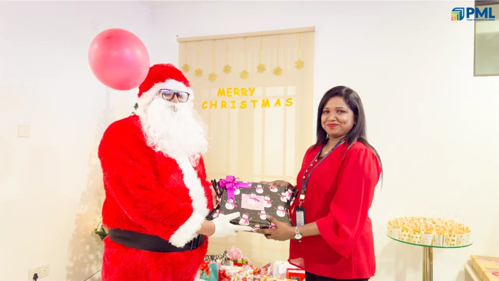 Employees receiving gifts from Santa in office 34