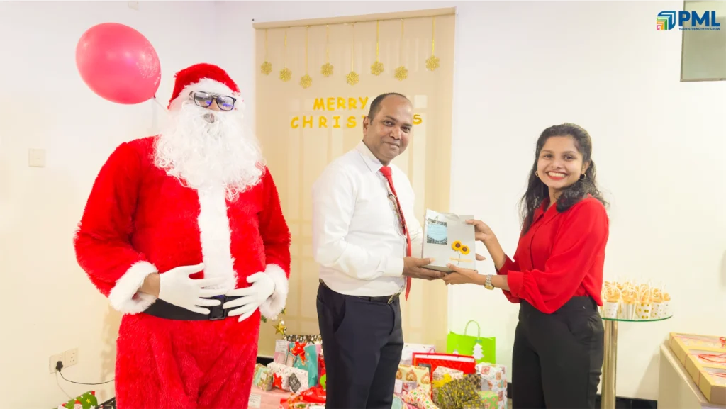 Employees receiving gifts from Santa in office 33