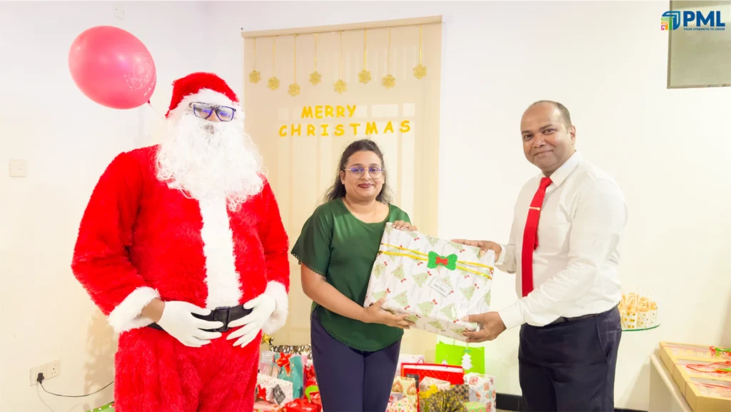 Employees receiving gifts from Santa in office 32