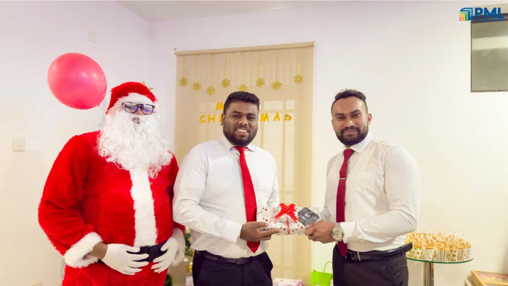 Employees receiving gifts from Santa in office 31