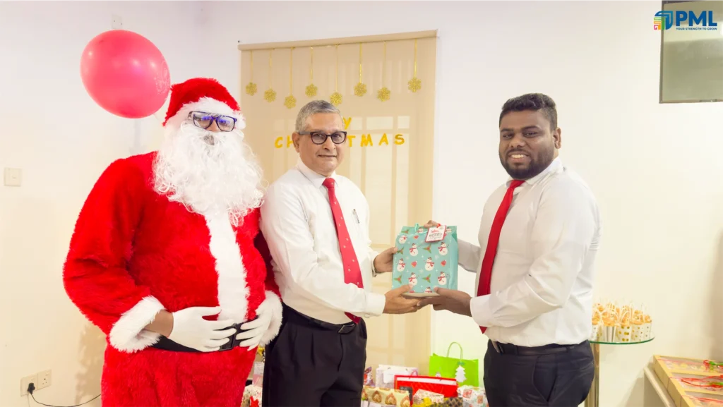 Employees receiving gifts from Santa in office 30