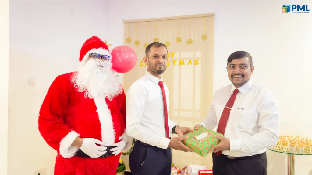 Employees receiving gifts from Santa in office 29