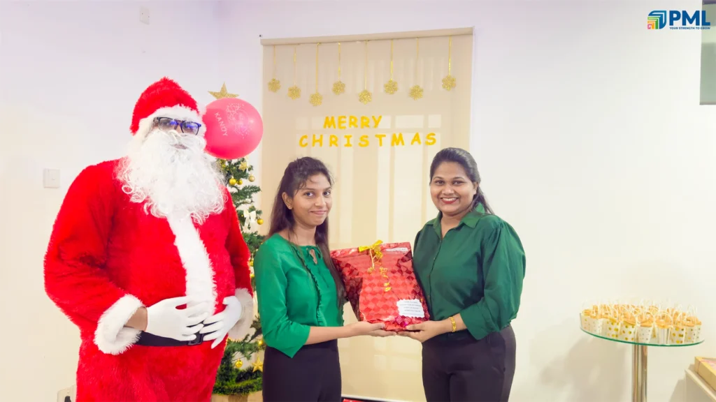 Employees receiving gifts from Santa in office 28