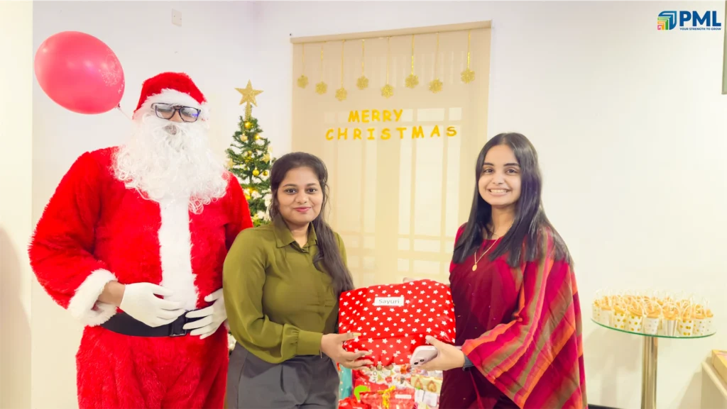 Employees receiving gifts from Santa in office 26