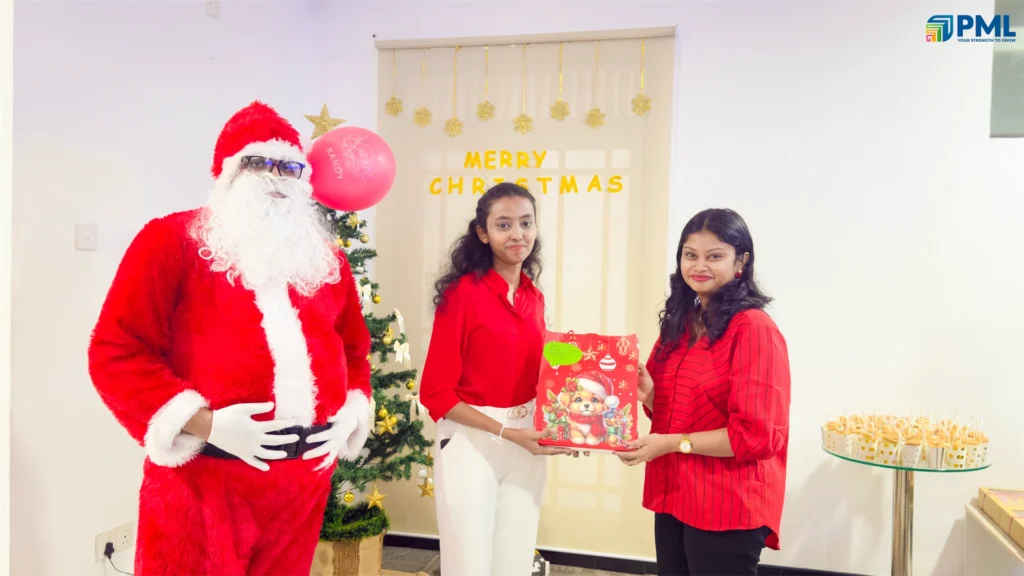Employees receiving gifts from Santa in office 24