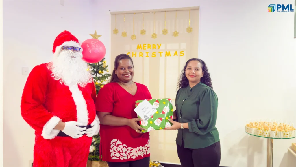 Employees receiving gifts from Santa in office 22
