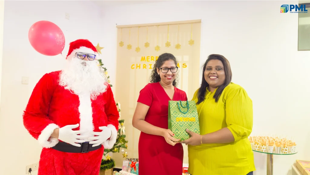 Employees receiving gifts from Santa in office 21