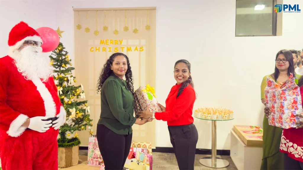 Employees receiving gifts from Santa in office 20