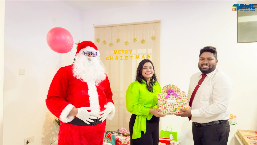 Employees receiving gifts from Santa in office 19