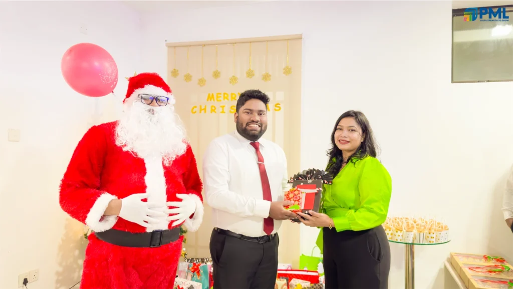 Employees receiving gifts from Santa in office 18