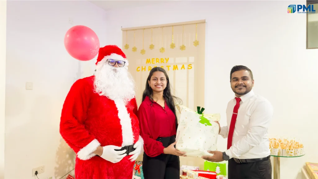 Employees receiving gifts from Santa in office 17