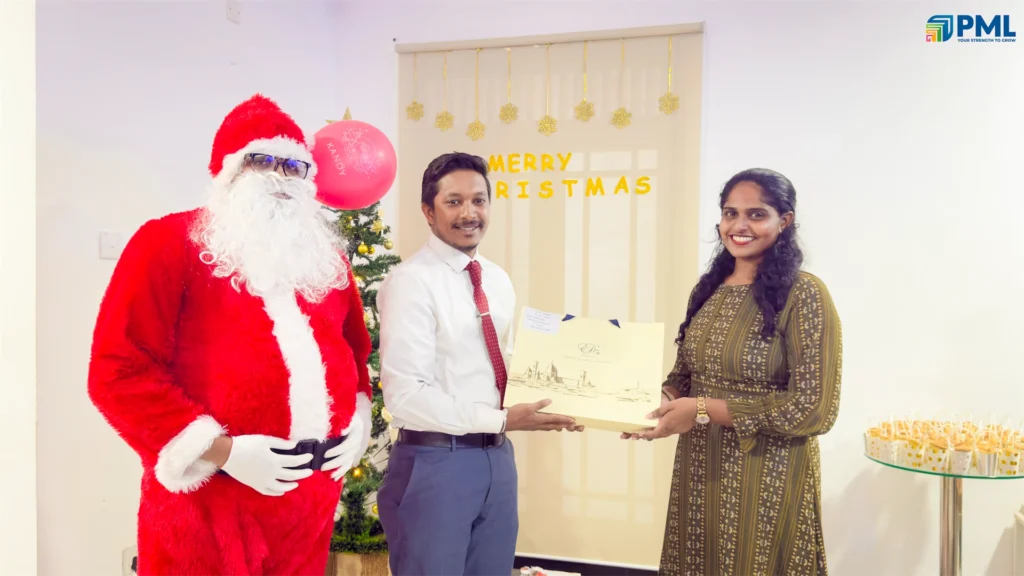 Employees receiving gifts from Santa in office 16