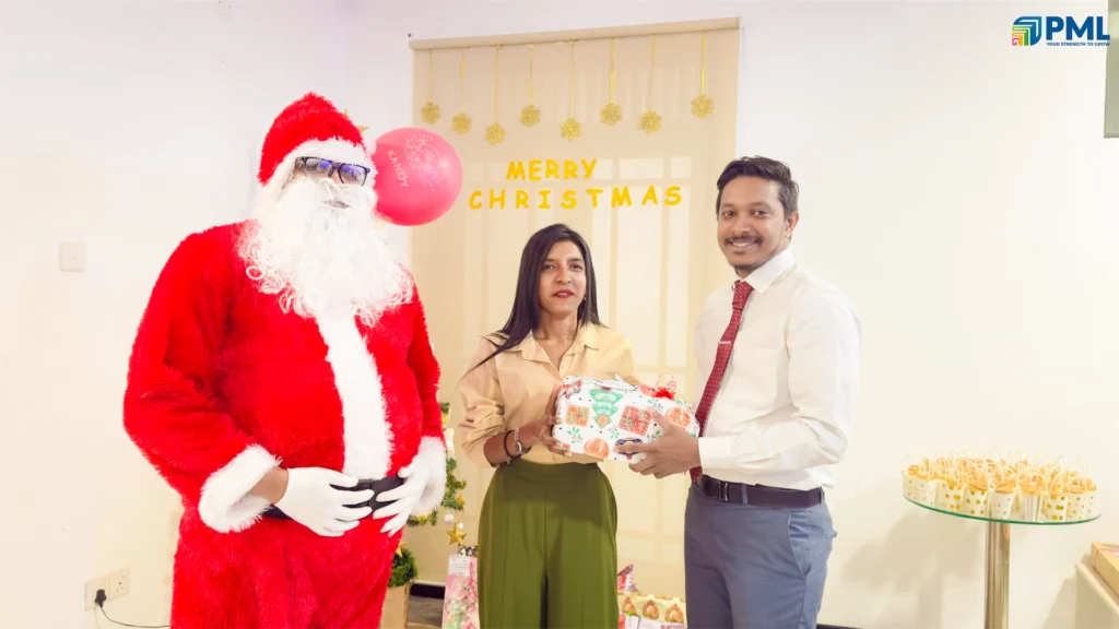 Employees receiving gifts from Santa in office 15