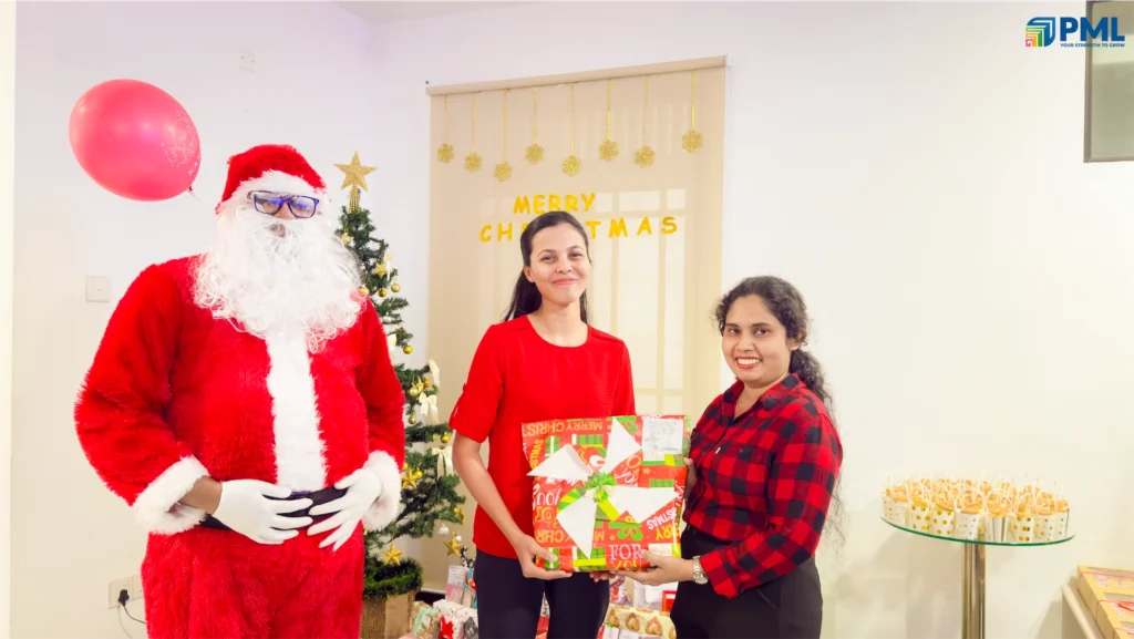 Employees receiving gifts from Santa in office 14