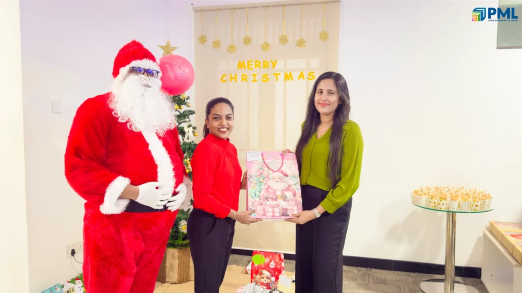 Employees receiving gifts from Santa in office 13