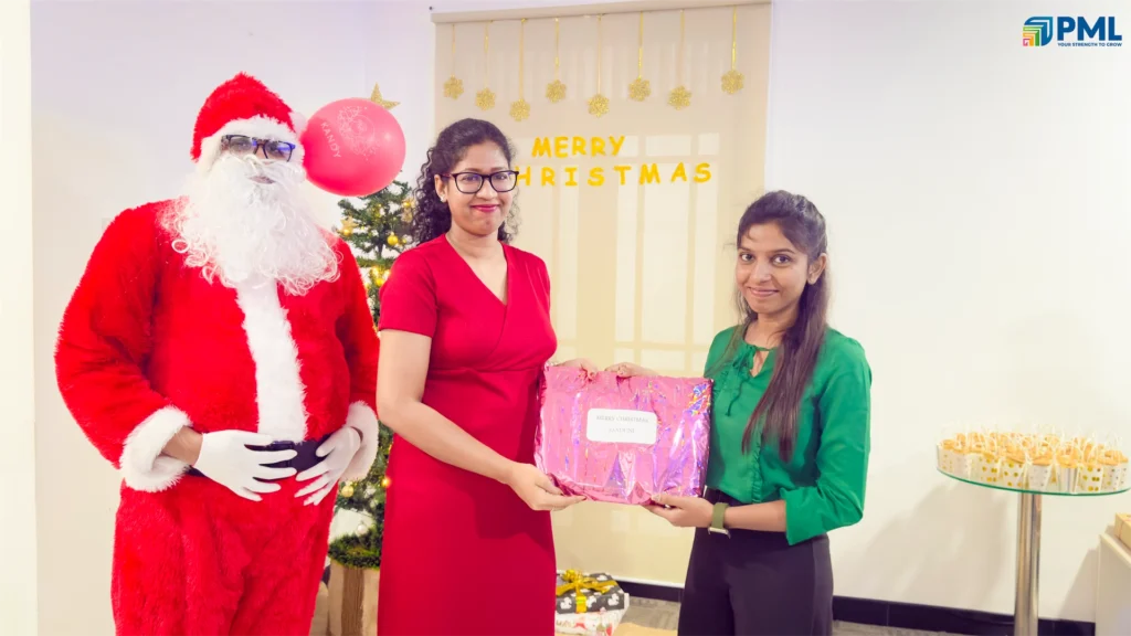 Employees receiving gifts from Santa in office 12