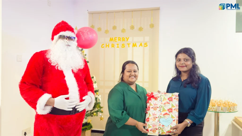 Employees receiving gifts from Santa in office 10