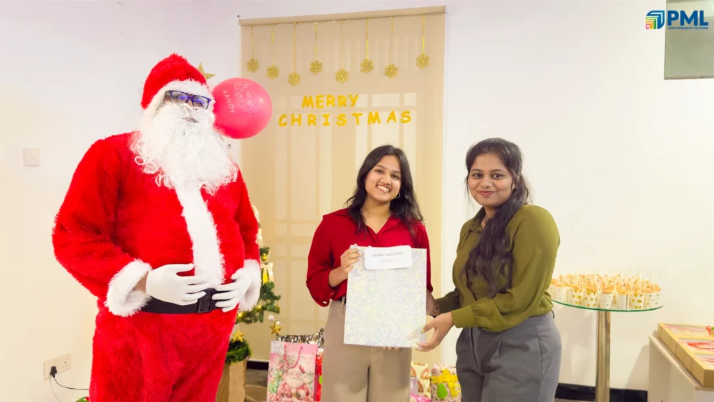 Employees receiving gifts from Santa in office 9