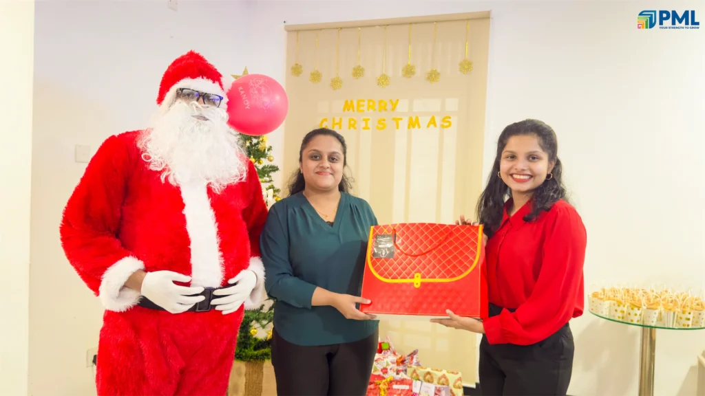 Employees receiving gifts from Santa in office 8