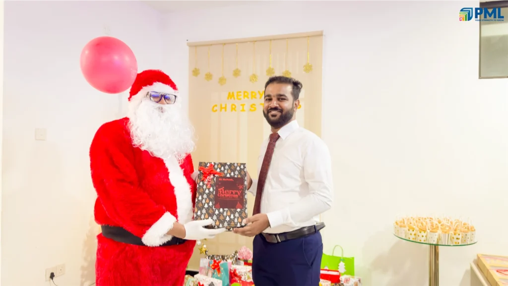 Employees receiving gifts from Santa in office 7