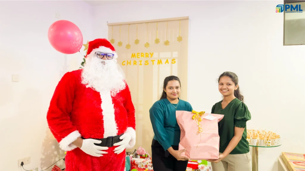 Employees receiving gifts from Santa in office 6