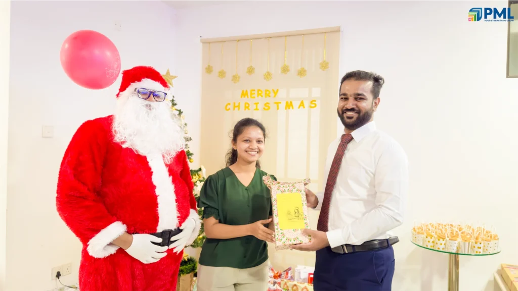 Employees receiving gifts from Santa in office 5