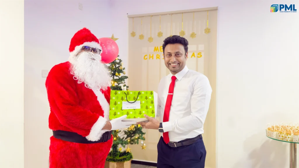 Employees receiving gifts from Santa in office 40