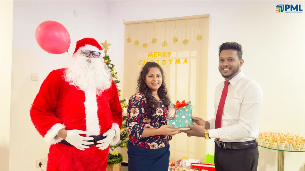 Employees receiving gifts from Santa in office 4