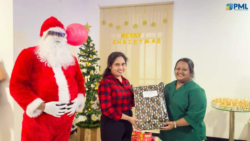Employees receiving gifts from Santa in office 3