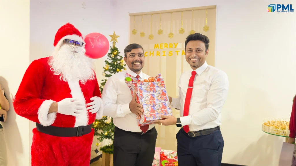 Employees receiving gifts from Santa in office 39