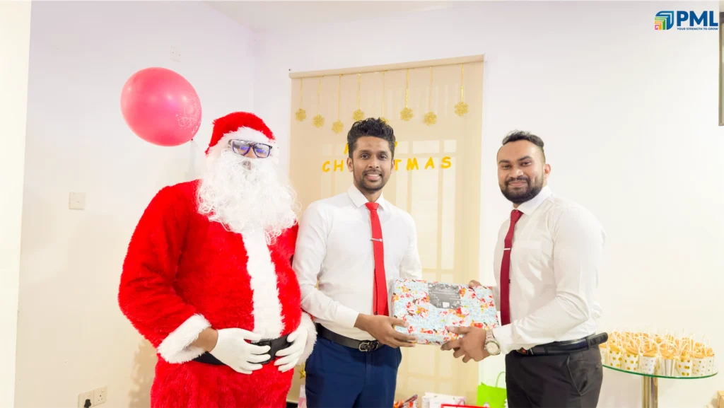 Employees receiving gifts from Santa in office 37