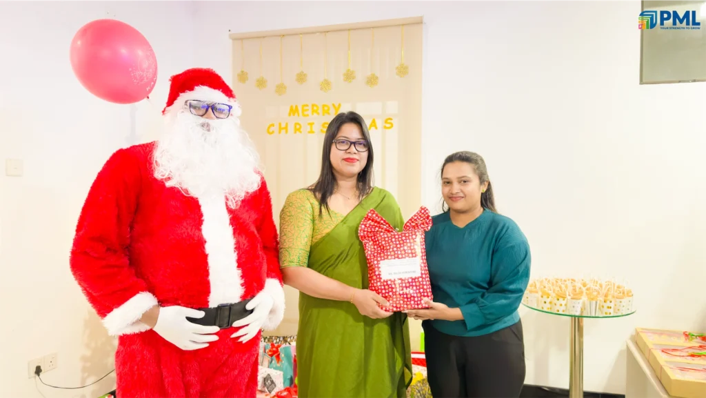 Employees receiving gifts from Santa in office 36